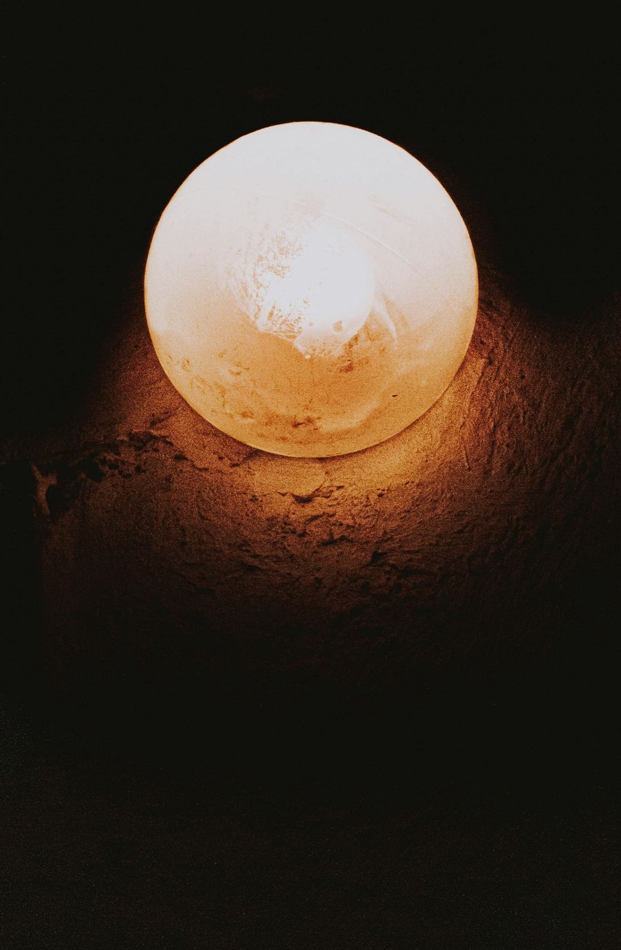 Carved sphere salt lamp on wooden table